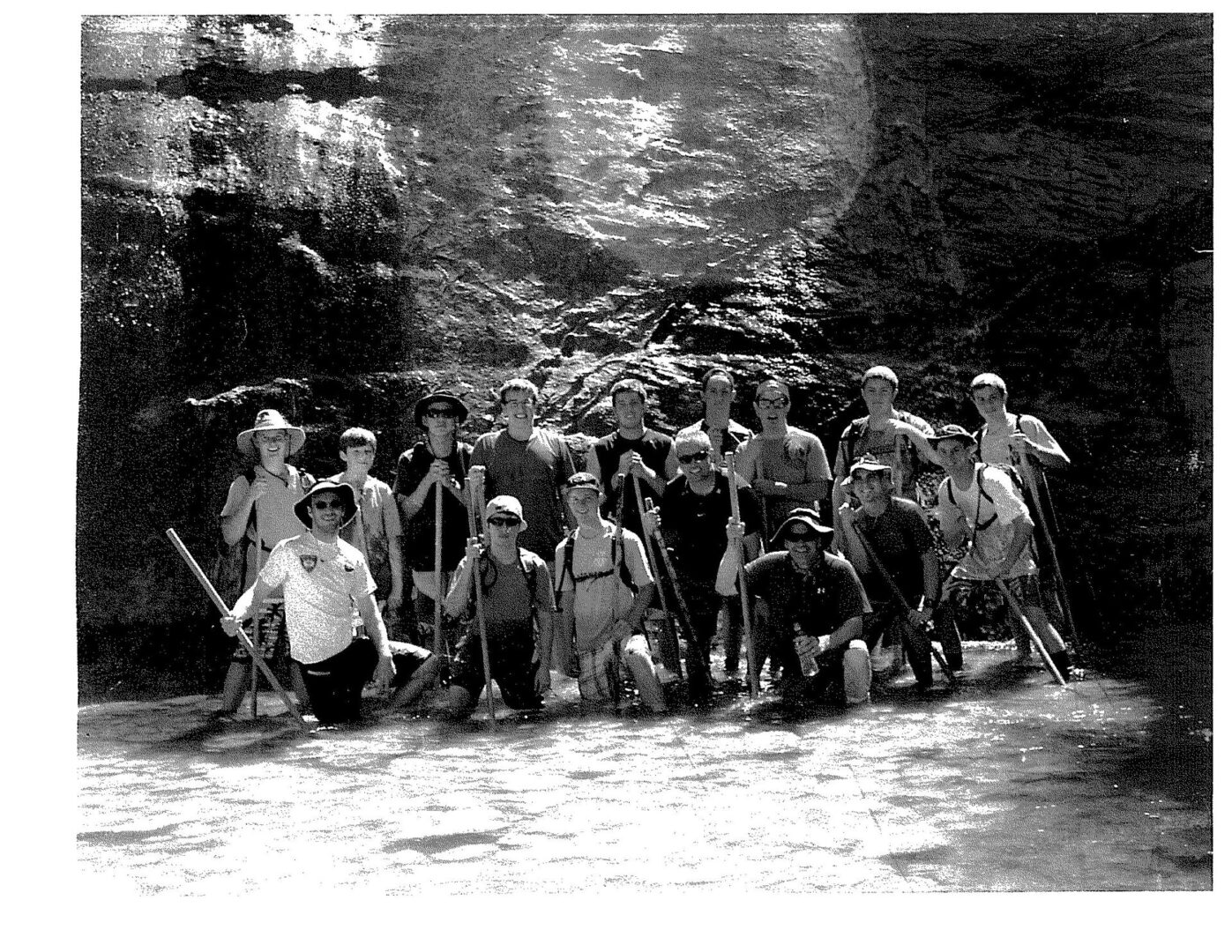 A group of people standing in the dirt.