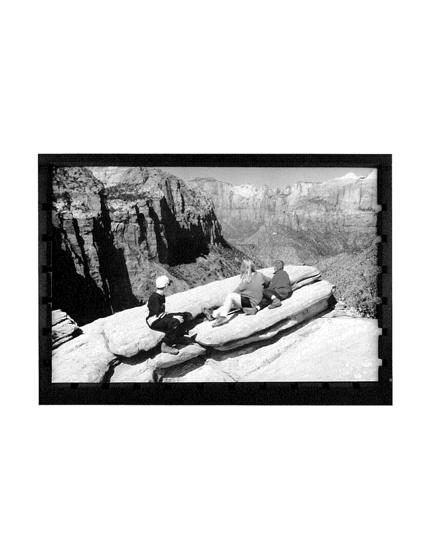 A black and white photo of two people in a boat.
