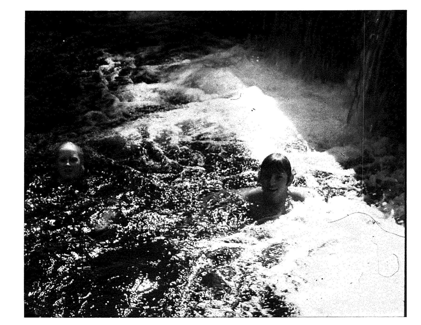 A black and white photo of water in the ground.