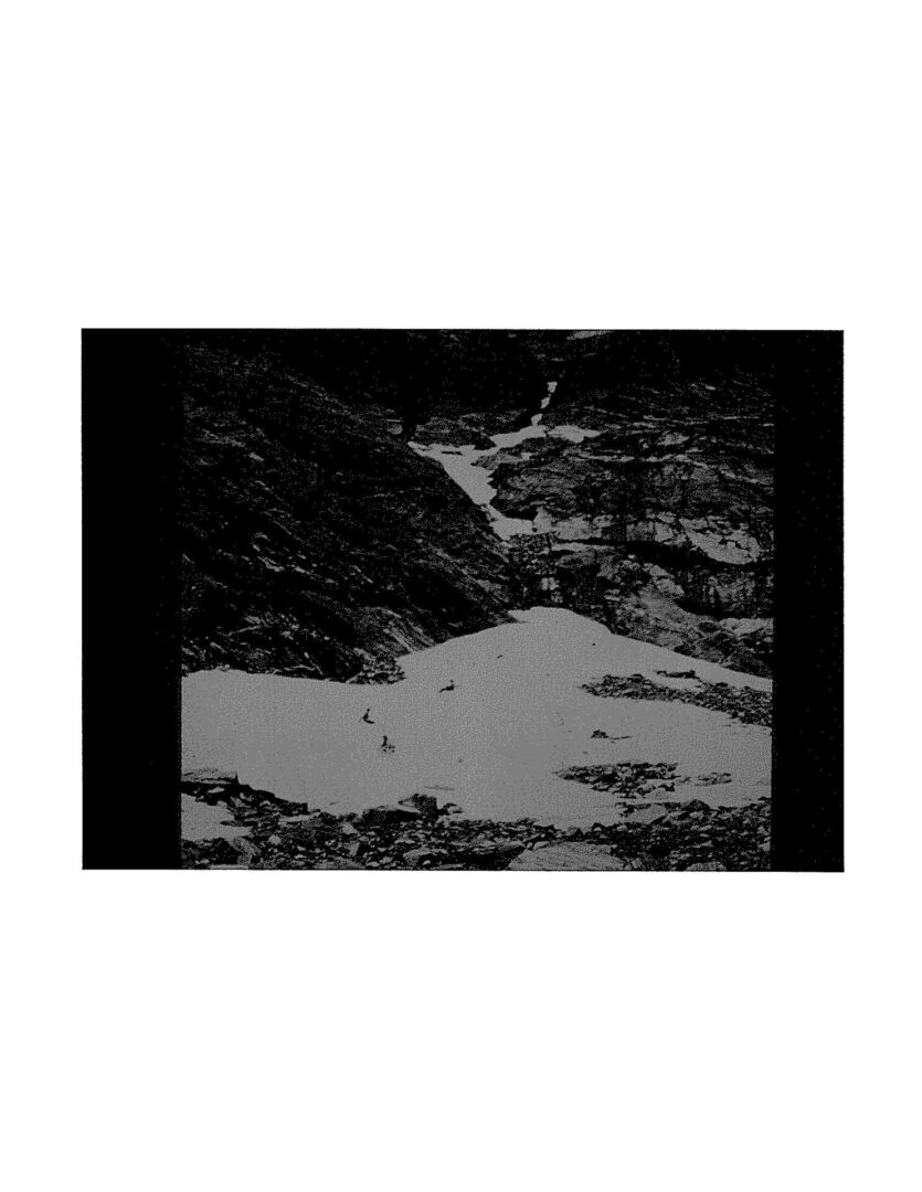 A black and white photo of a mountain with snow.