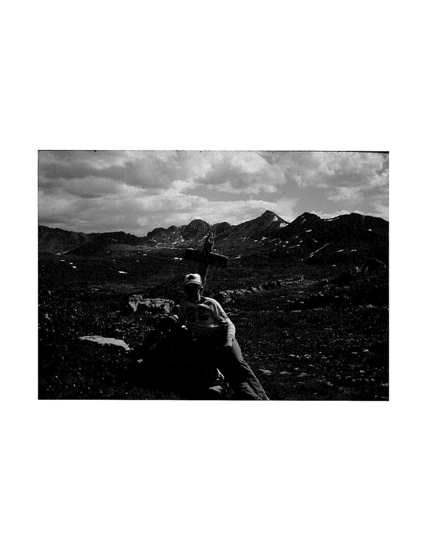 A black and white photo of a person in the field