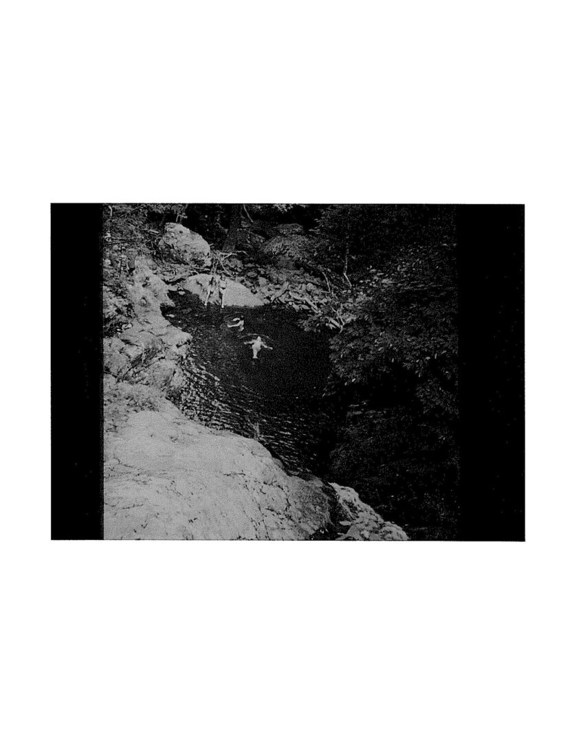 A black and white photo of a person walking on the ground.