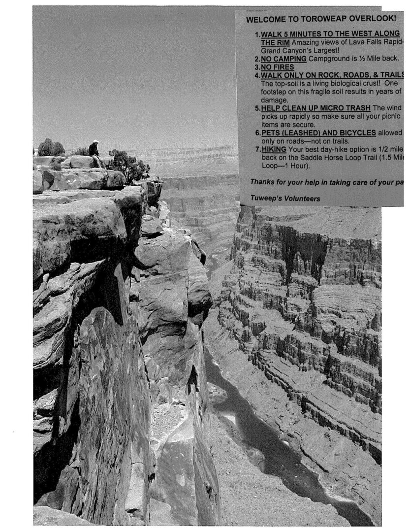 A man standing on top of a cliff.