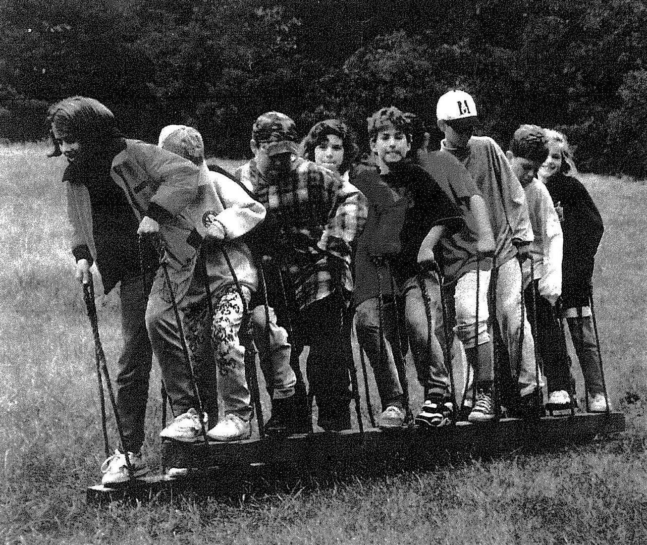 A group of people standing in the grass.
