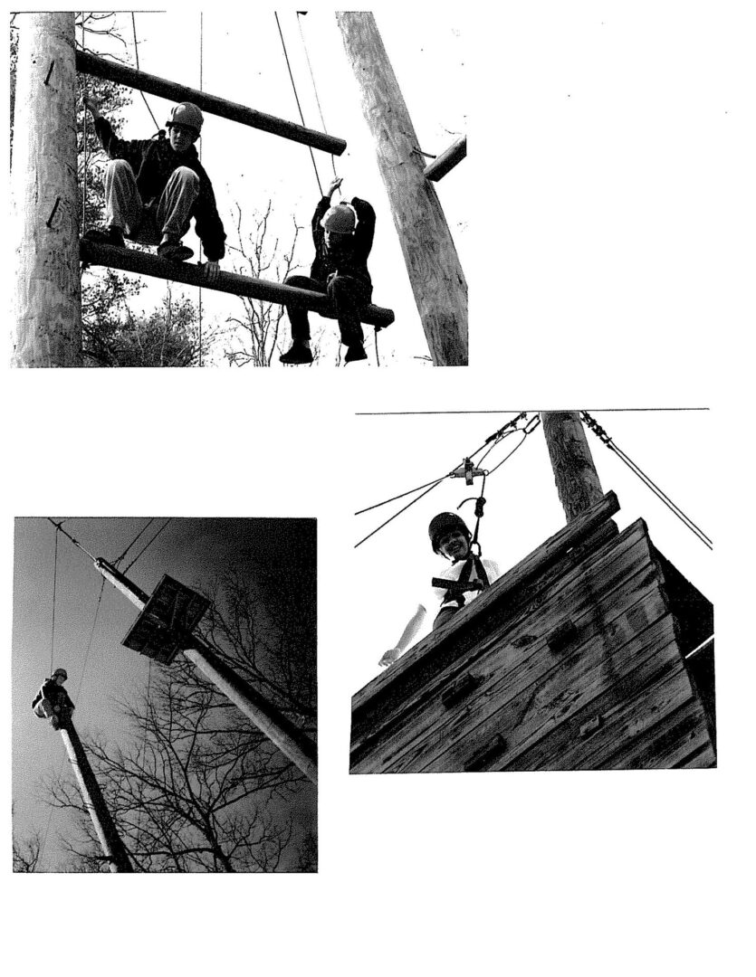 A black and white image of two men working on power lines.