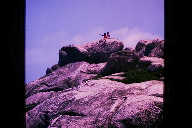 A person standing on top of a rock formation.